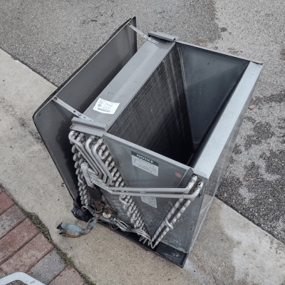 coil cleaning on an air conditioning unit, using specialized tools to remove dirt and debris from the coils. This essential maintenance service improves the efficiency and lifespan of your HVAC system by ensuring optimal heat exchange and reducing energy consumption.